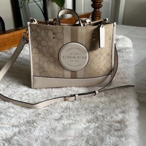 Coach Beige and cream Signature Canvas and leather stripe Dempsey satchel.